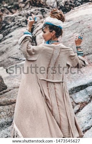 young tribal style woman with lot of boho accessories outdoors