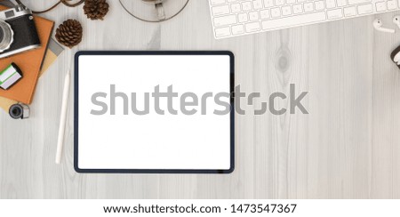 Top view of professional photographer's workplace with blank screen tablet 