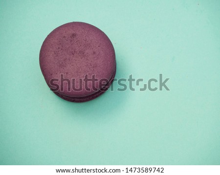 Bright colorful macarons on a pastel blue background. space for text, close up