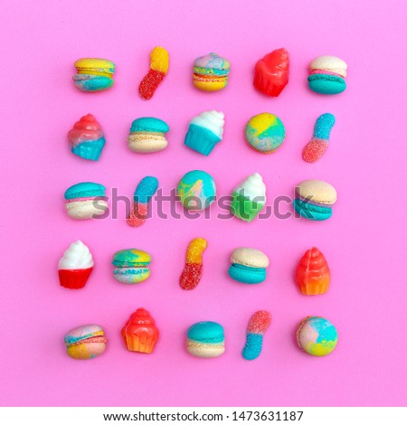 Macaroons and sweet mix on pink background.  Stylish flat lay food art