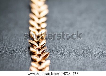 Gold chain on dark background. Shallow depth of field. Selective focus.  