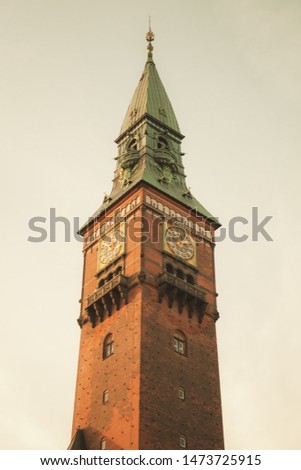 Clock tower of Copenhagen city hall, Denmark. Vintage toned photo with retro tonal correction filter effect