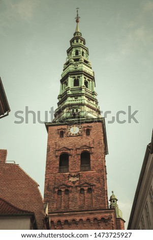 Nikolaj Kirke or Nikolai Church located in old town of Copenhagen, Denmark. Vintage toned photo with retro tonal correction filter effect