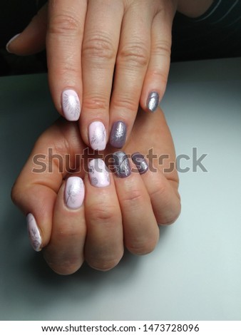 Manicure in gentle colors with winter pattern.