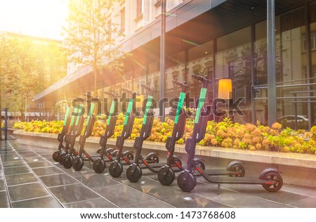 Electric Scooters For Public Share Standing Outside In European City Center, Public Mobile Transportation Royalty-Free Stock Photo #1473768608