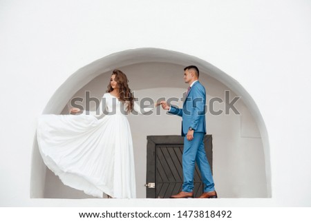 Photo in the castle. Stylish and beautiful. Princess's dress. The guy in a blue suit. Dress flutters in the wind