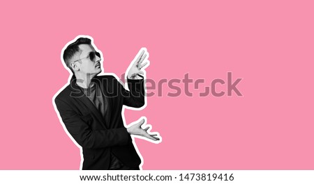 Collage in magazine style, trendy stylish confident positive crazy man in sunglasses pointing ad. Salesman promotion offer ad Trendy pink color background copy space sale banner Discount sales concept Royalty-Free Stock Photo #1473819416