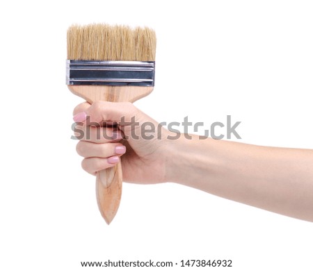 Hand holding building paint brush on white background isolation