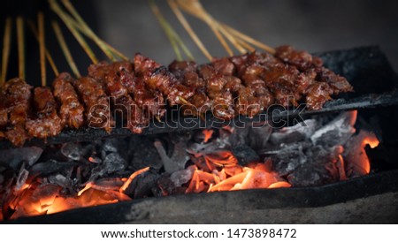 satay and rice cake is the one of favourite food in Indonesia Royalty-Free Stock Photo #1473898472