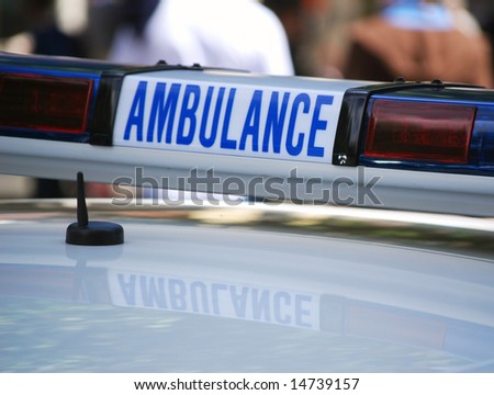 Close-up of ambulance sign on vehicle in high street