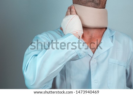 man with cervical collar and hand with bandage