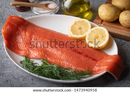 raw salmon fillet on gray background