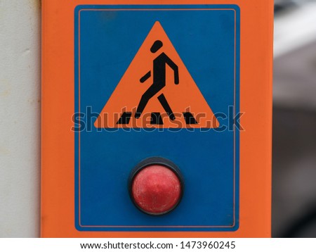 Pedestrian crossing sign with a big red button. Road safety.