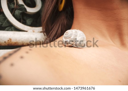 snail shell on girl's collarbones for background.