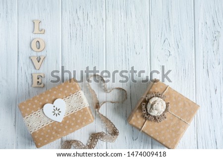 Two gift boxes on a light wooden background with a place for Copispeys. Frame for greeting text with boxes of gifts. Congratulations on the New Year, Mother's Day, Valentine's Day