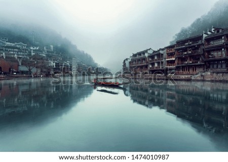 Took this travel photography back at China. Love the reflection on the river and the boat happened to be in the middle.