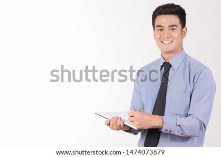 Young Asian working-age young men Attractive Take notes and check things with pens and notebooks. Smiling face and emotions