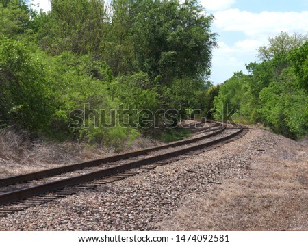 Curving railroad track in the outskirts of a city