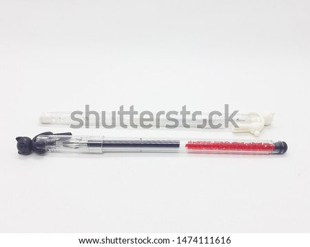 Artistic Cute Monochrome Working Desktop Pen with Cat Ornaments on Top in White Isolated background