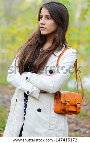 The beautiful young girl in autumn park