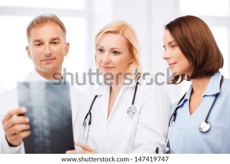 healthcare, medical and radiology concept - doctors looking at x-ray