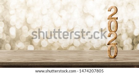 Happy New Year 2020 wood with sparkling star on brown wood table with gold bokeh background,Holiday festive celebration concept.Banner mock up for display of product or design content Royalty-Free Stock Photo #1474207805