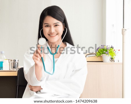 Portrait of a woman doctor and holding stethoscope in the examination room. Happy beautiful doctor and smiling in hospital or clinic.