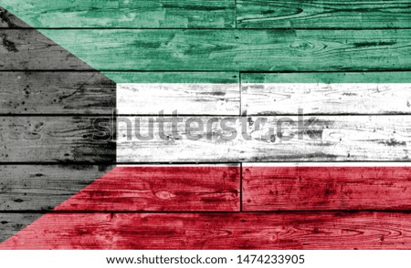 Kuwait flag painted on wooden background, closeup.