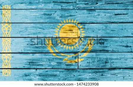 Kazakhstan flag painted on wooden background, closeup.