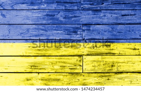 Ukraine flag painted on wooden background, closeup.