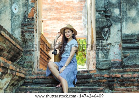 Young asian woman traveler traveling at Wat Borom Puttharam in Ayutthaya ,Thailand. Travel concept.