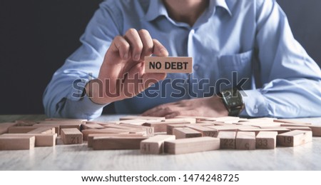 Man holding wooden block. No Debt Royalty-Free Stock Photo #1474248725