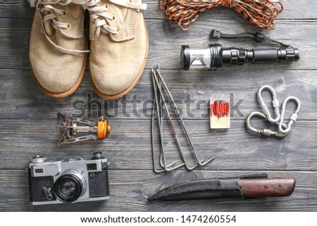 Set of items for camping on wooden background