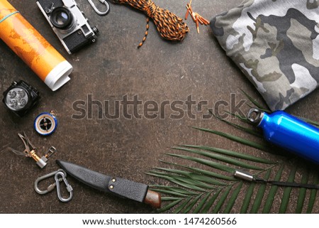 Frame made of items for camping on dark background