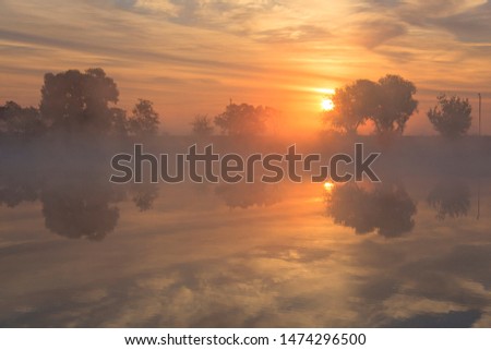 Sunrise over the river in summer