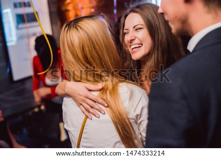 Fashion happy brown hair surprised excited woman or girl with pigtail laughing smiling hugging with friend on celebration birthday party in city cafe night club premium restaurant with girls friends Royalty-Free Stock Photo #1474333214