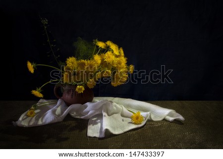 Still life with yellow dandelions