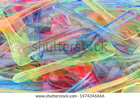 Coloured plastic ice cream spoons background