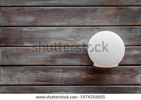 Wireless speaker as music gadgets on wooden background top view mock up