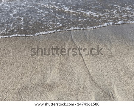Waves on the sandy ocean beach with clear sunny weather in vacation time
