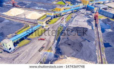 UAV aerial photography of China, coal factories, internal sprinkler clean formation of artificial rainbow. Large transport vehicles are transported back and forth.