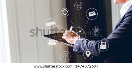 Asian business man using digital tablet in office to operate the network, e commerce online at the office, The media reaches the operational guidelines, for panoramic banner background with copy space Royalty-Free Stock Photo #1474372697