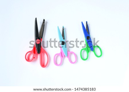 Top view colorful scissors for craft on white background. Accessories for children's hobby.
