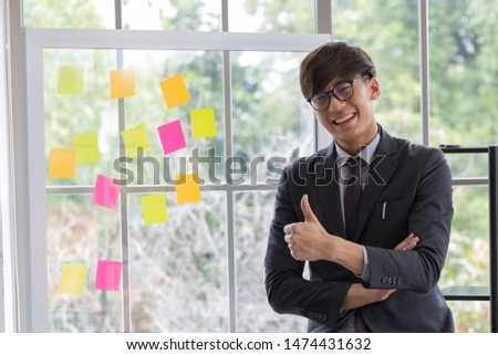 Portrait asian handsome business man model wear suit showing like sign (Thumbs up, hands gesture) with his finger. Meeting room . White background