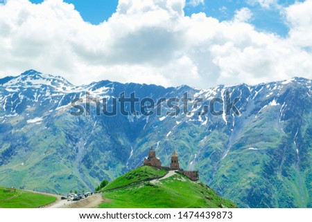 The church is built in the mountains. Beautiful natural landscape. The sky with clouds.