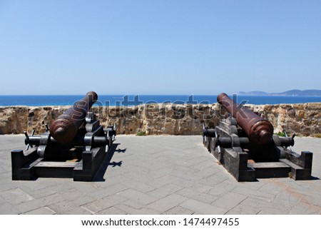 Italy, Sardinia: Old cannons on the Algero bay.