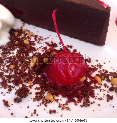 Macro photo chocolate cake with ice cream and cherry. Food product dessert chocolate cake on white platte