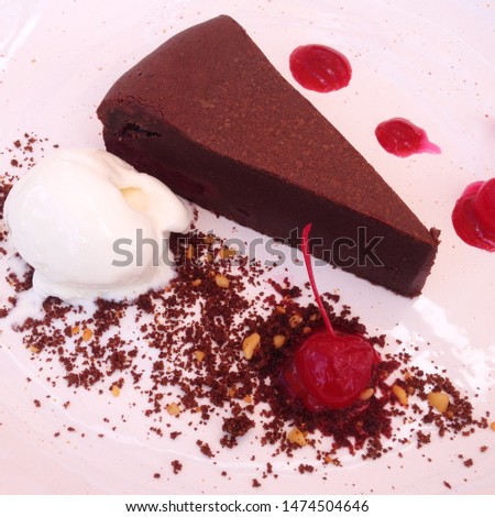 Macro photo chocolate cake with ice cream and cherry. Food product dessert chocolate cake on white plate