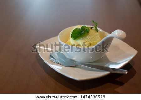 Durian and vanilla flavor ice cream with  mint leaves topping in the spoon ceramic cup is amazing the taste and ready to eating 