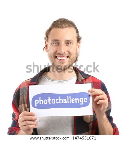 Male blogger holding paper with text PHOTO CHALLENGE on white background